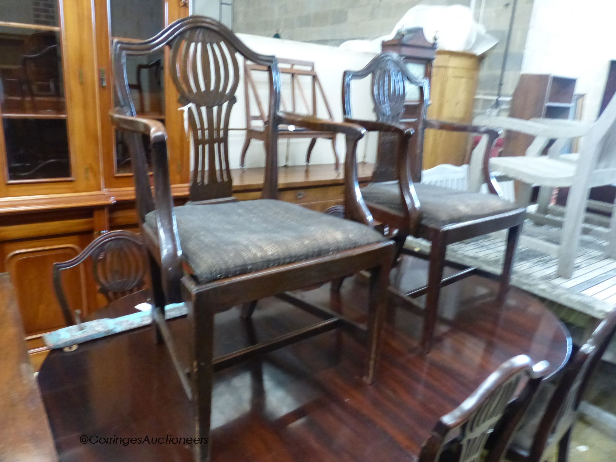 A set of eight Hepplewhite style mahogany dining chairs. (two having arms)